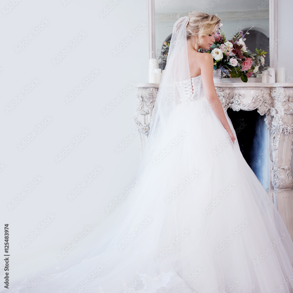 Charming young bride in luxurious wedding dress. Pretty girl, photo Studio Charming young bride in luxurious wedding dress. Pretty girl, photo Studio