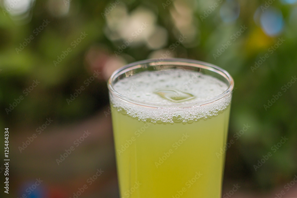 Sugarcane juice with piece of sugarcane on wooden background Sugarcane juice with piece of sugarcane on wooden background