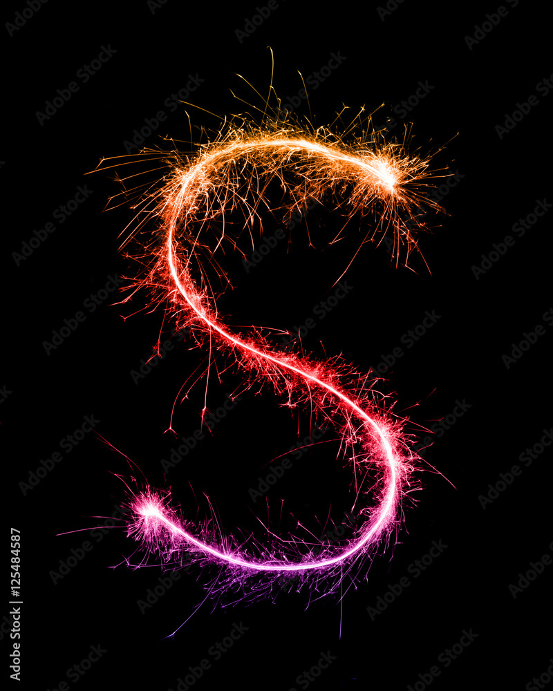 Sparkler firework light alphabet S at night Sparkler firework light alphabet S at night