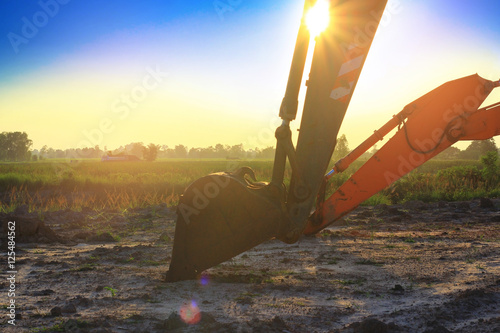 Backhoe construction scoop stop work with rubble stone in the site