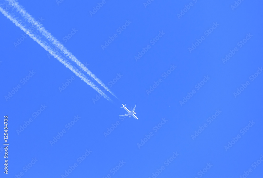 the plane flies on blue sky background the plane flies on blue sky background