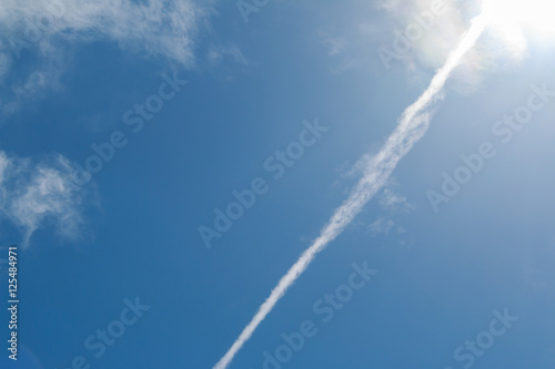 Trace of plane in the sky clouds. Abstract background.
