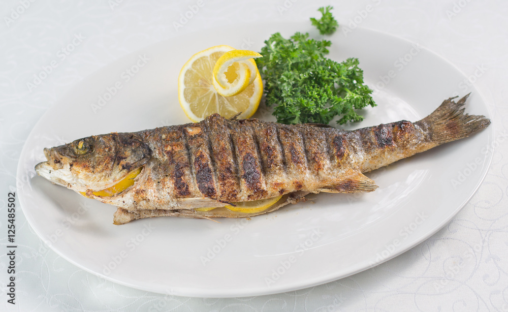 Fish seabass (labrax),fish on the grill,Greek cuisine Fish seabass (labrax),fish on the grill,Greek cuisine