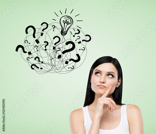 Girl with question marks on green background