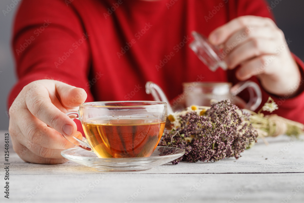 male hands holding cup with hot herbal tea. Winter and Christmas male hands holding cup with hot herbal tea. Winter and Christmas