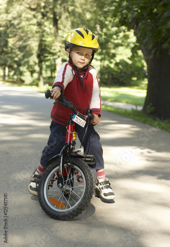 Young boy riding his first bicycle with training wheels  © Petr Bonek
