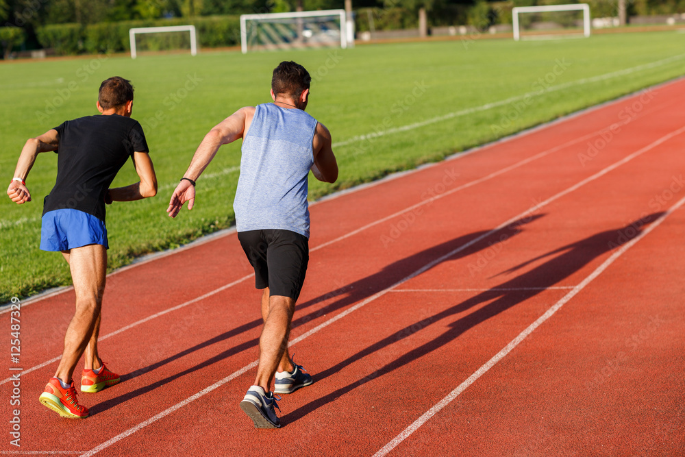 Obraz premium Active strong men in sportswear running on sammer sunny day