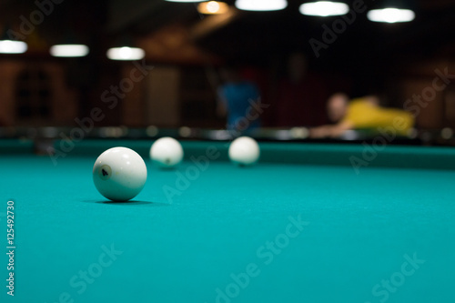 Russian billiard in club: balls on green game table cloth