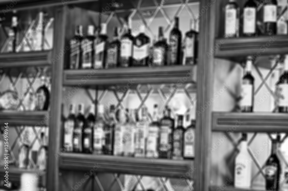 Blur efferct of several types of bottled alcohol are displayed o