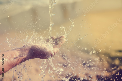 Close up of human hand catching water  ocean beach outdoors background
