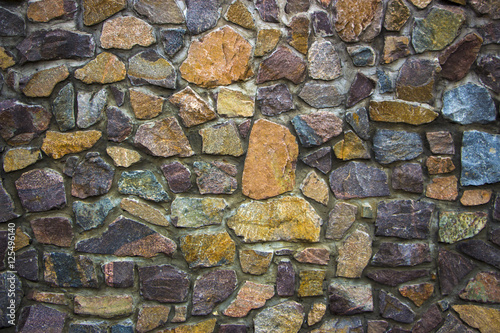 wall of granite boulders of different colors