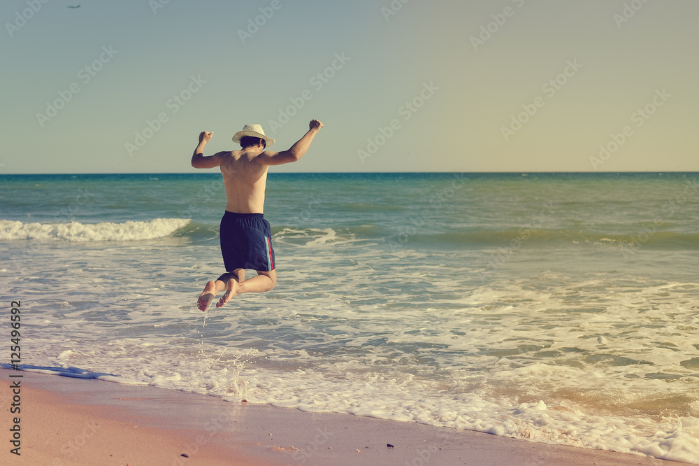 Portrait of a fit muscular male model standing in clear warm tropical waters with lots of copy space Portrait of a fit muscular male model standing in clear warm tropical waters with lots of copy space
