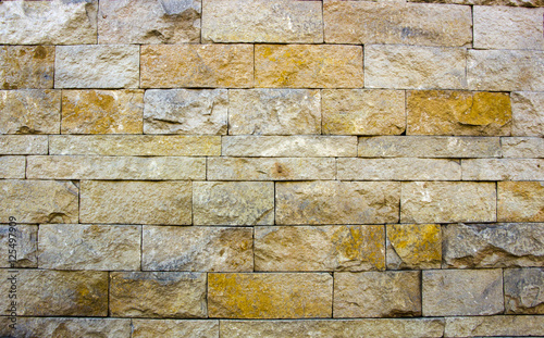 house wall decorated with multi-colored sandstone wall tiles