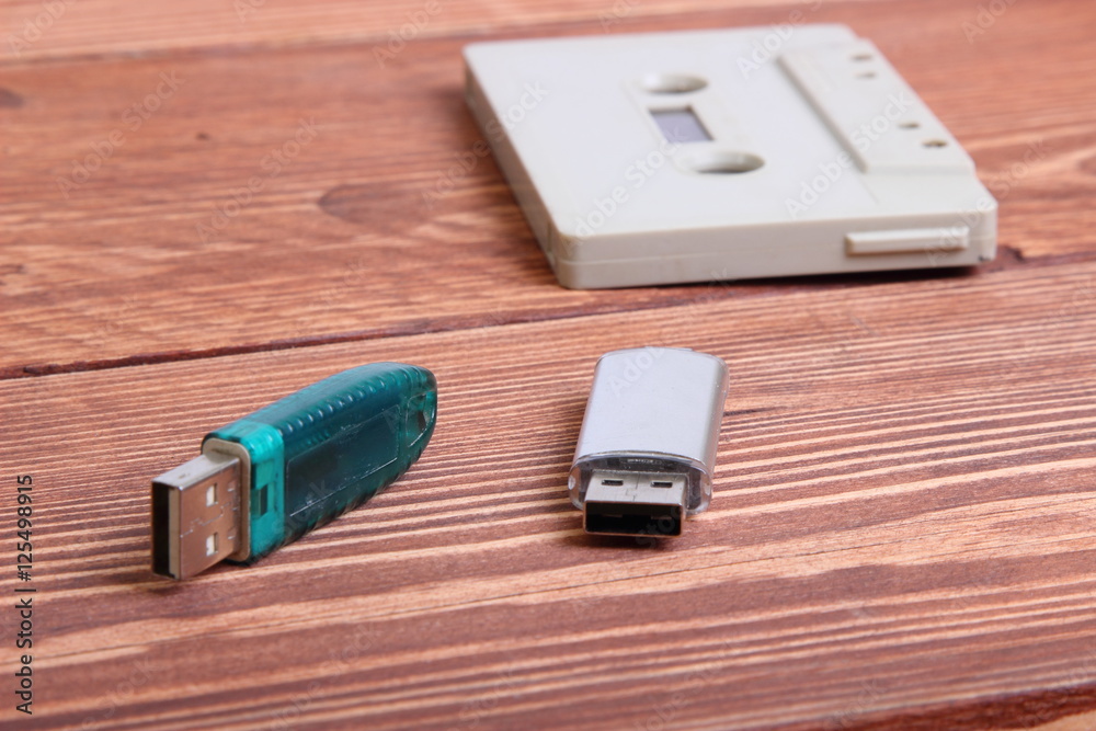 flash disk and audio cassette on wooden background flash disk and audio cassette on wooden background