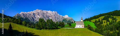 Alps panoramic landscape view with a little church