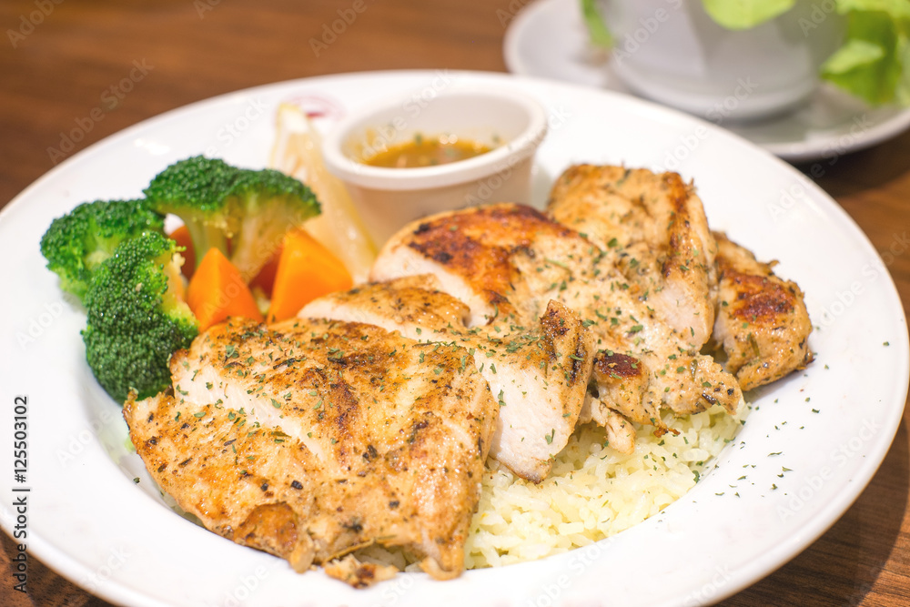 garlic rice with fried chicken on wood table