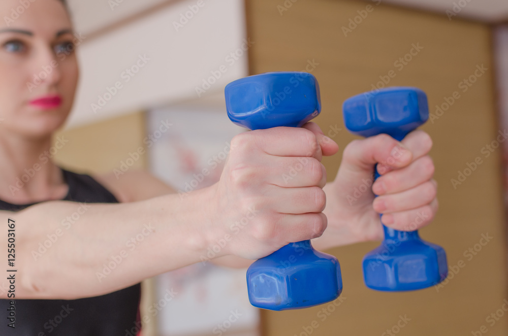 woman is making exercises in the hall