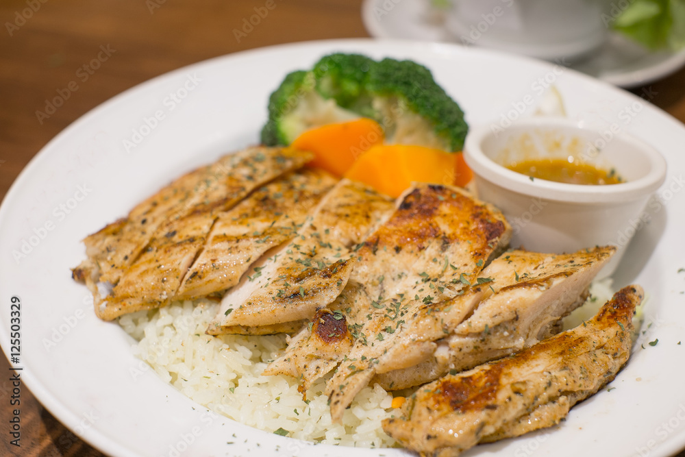 garlic rice with fried chicken on wood table