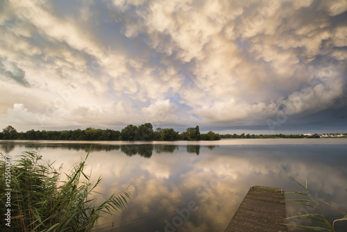 Stunning dramatic mammatus clouds formation over lake landscape © veneratio
