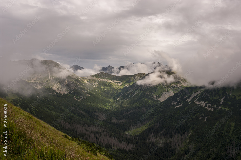Panorama of amazing summer mountains under the clouds