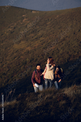 Young friends hike on mountain