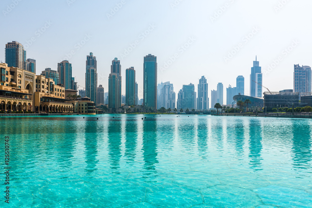 Obraz premium Skyline view of Dubai, UAE, reflected in a pool