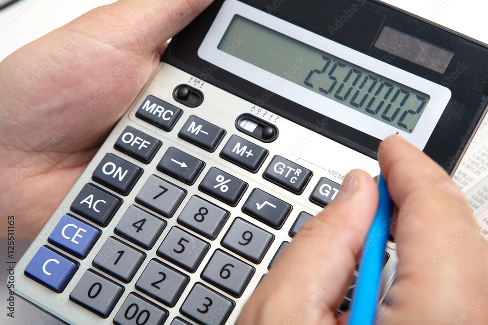 Businessman with calculator in the office Businessman with calculator in the office