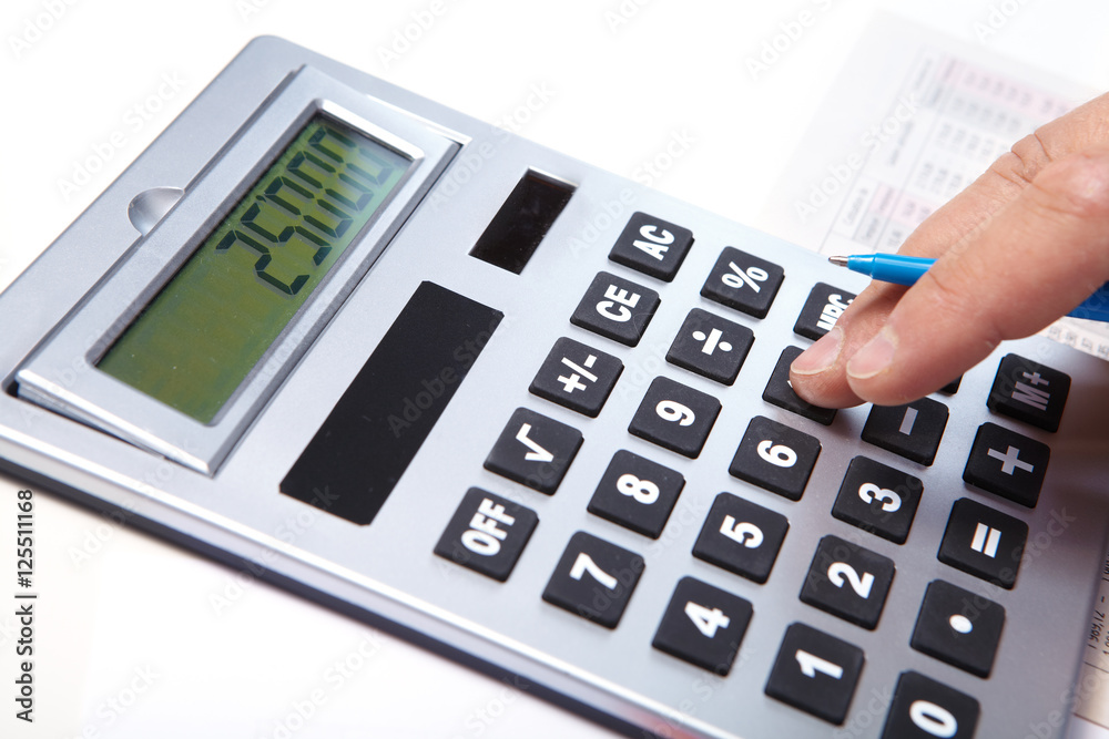 Businessman with calculator in the office Businessman with calculator in the office