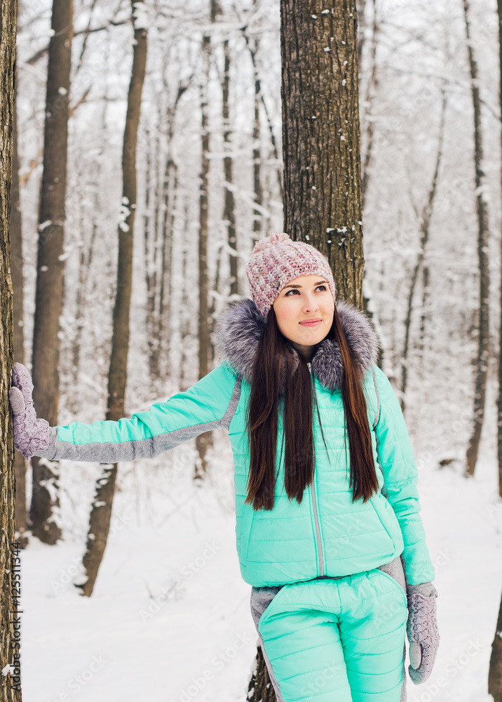 Beautiful winter portrait of young woman in the snowy nature Beautiful winter portrait of young woman in the snowy nature