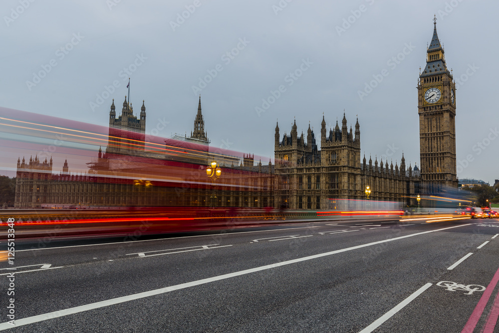 Red bus in motion and Big Ben, the Palace of Westminster. London, the UK.
