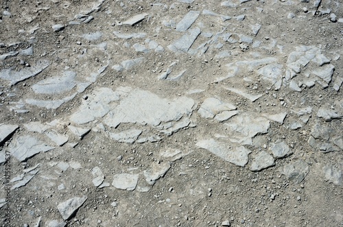 Texture of the stones on the ground. The texture of a rocky dirt road. Mountain road.