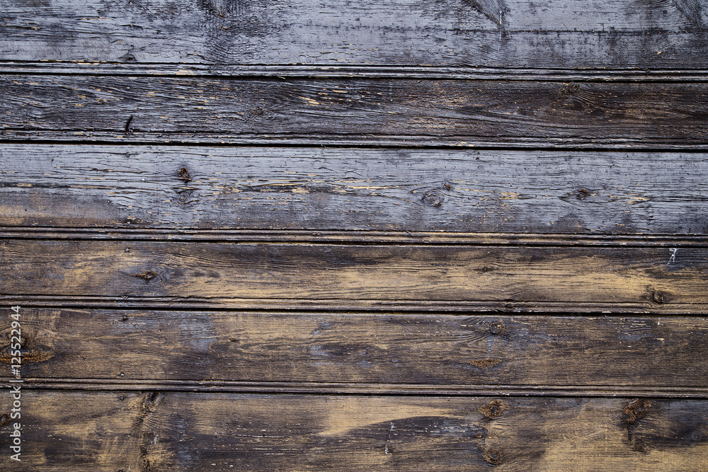 Fototapeta premium Old wooden wall with cracked paint traces