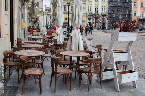 Empty tables of outdoor cafe in city center of Lviv, Ukraine in Europe © photo_superteam