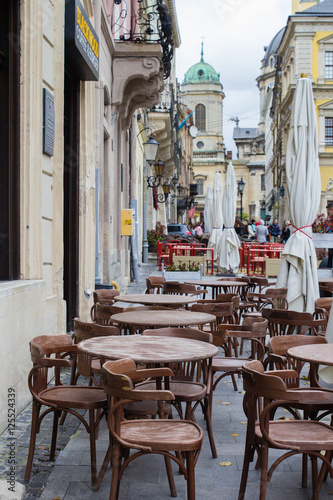 Empty tables of outdoor cafe in city center of Lviv, Ukraine in Europe