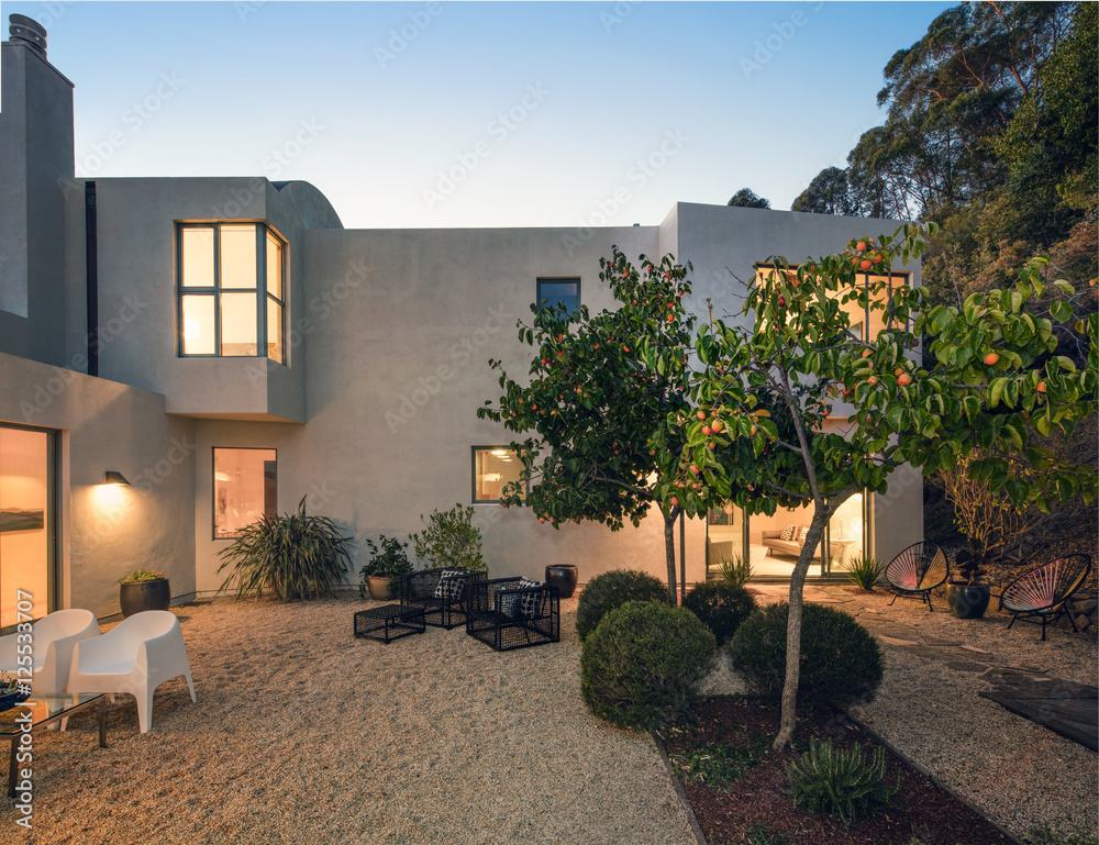 Modern Mediterranean home exterior at twilight. Stock Photo | Adobe Stock