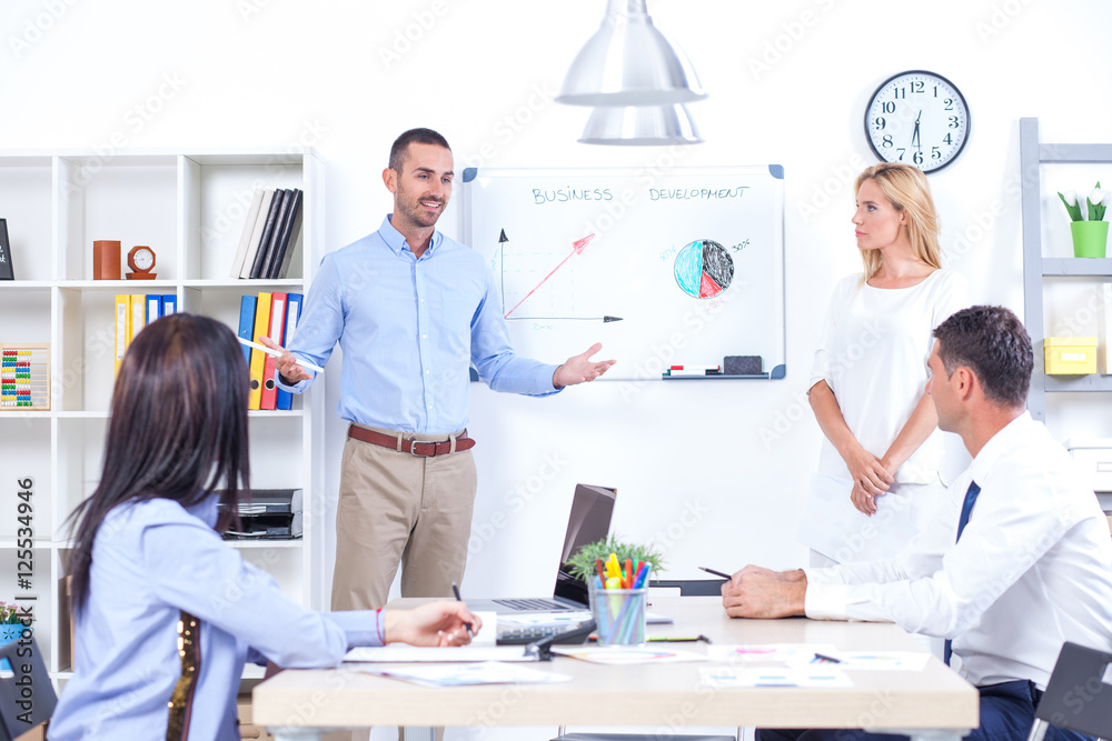 Group Of Business People Having Meeting In Office. Business partners discussing documents and ideas at meeting Group Of Business People Having Meeting In Office. Business partners discussing documents and ideas at meeting