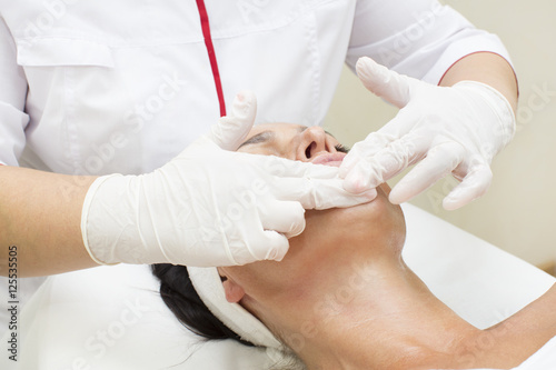 Process of massage and facials in beauty salon