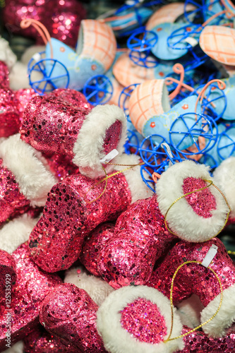 Colorful close up details of christmas fair market. Felt boots balls decorations for sales.