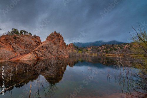 Red rocks in a calm pond.
