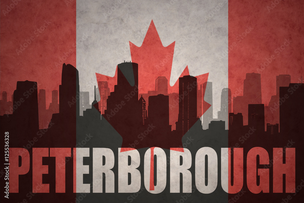abstract silhouette of the city with text Peterborough at the vintage canadian flag