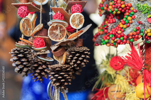 Colorful close up details of christmas fair market. Fir-cone balls decorations for sales.