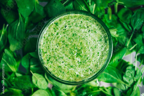 Fresh green juice smoothie made with organic green fruits and vegetables. top view, the texture of the leaves. The concept of a healthy lifestyle