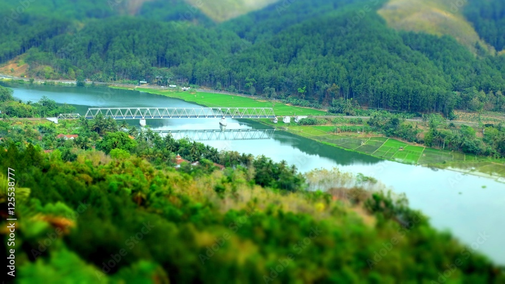 TIlt shift view of train bridge across serayu river in Indonesia TIlt shift view of train bridge across serayu river in Indonesia