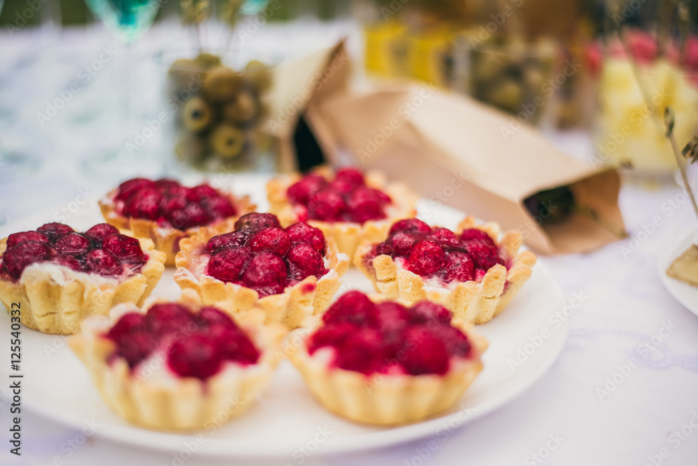 tartlets with raspberries on white background tartlets with raspberries on white background