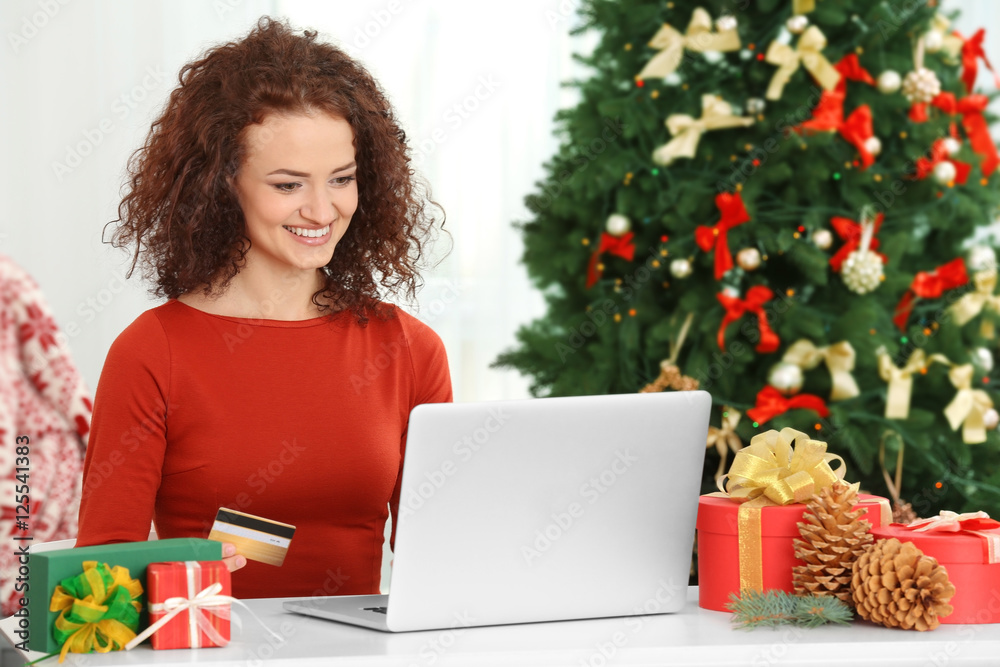 Young woman ordering Christmas gifts online Young woman ordering Christmas gifts online