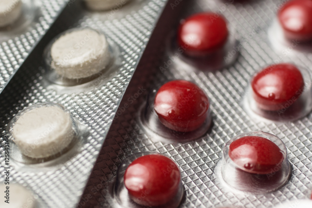 Multiple pills depicting medical treatment or pahrmaceutical ind