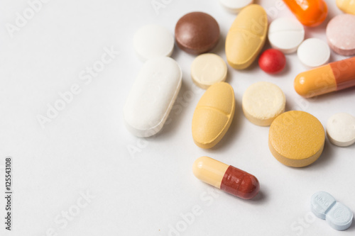 Multiple pills depicting medical treatment or pahrmaceutical ind