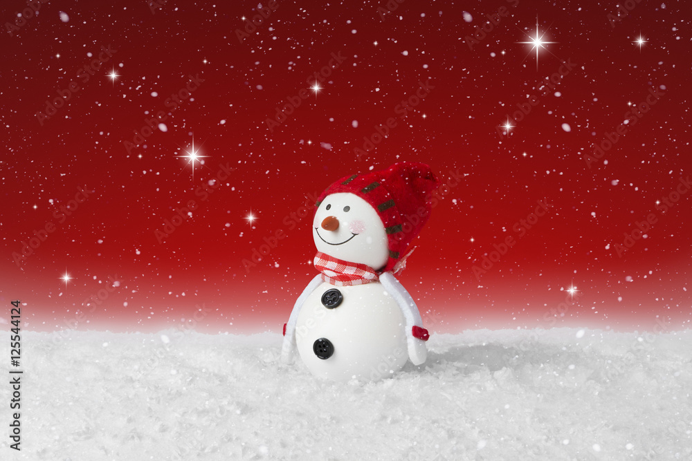 Snow falling on a White Christmas decoration snowman
