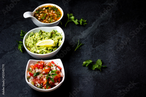 Tableau sur toile Traditional Latin American sauces Guacamole, Salsa, chili Pebre, slate backgroun