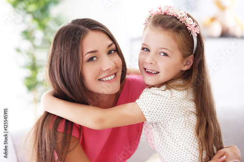 Cute girl with mother at home